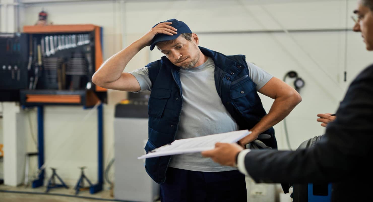 Distraught car mechanic going through problematic