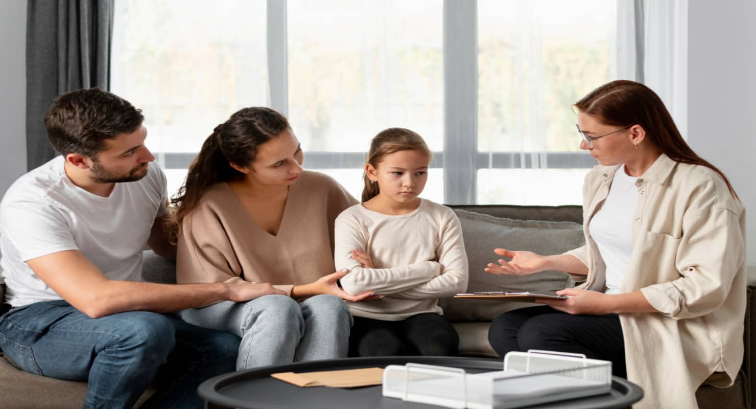 Medium shot therapist discussing with family