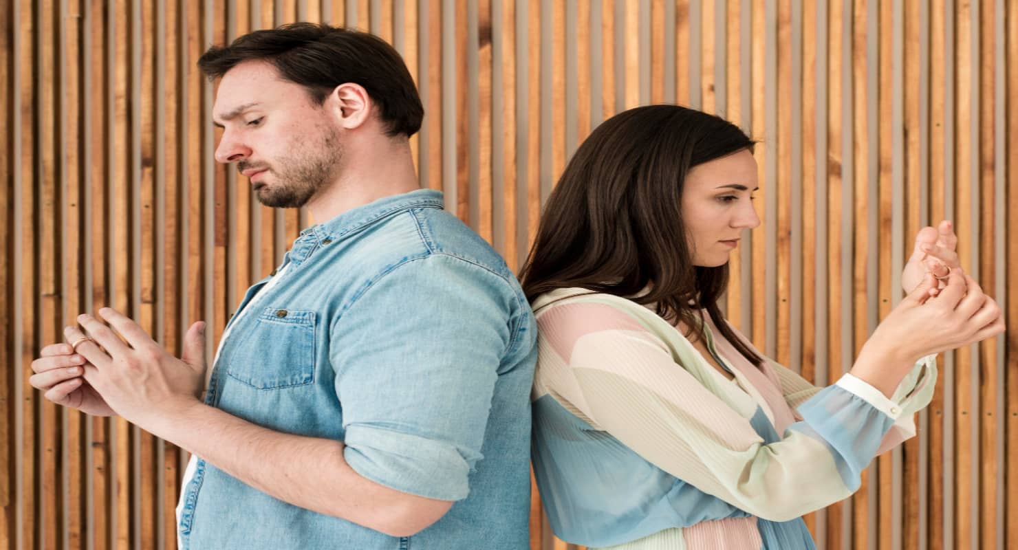 Adult man and woman taking wedding rings off