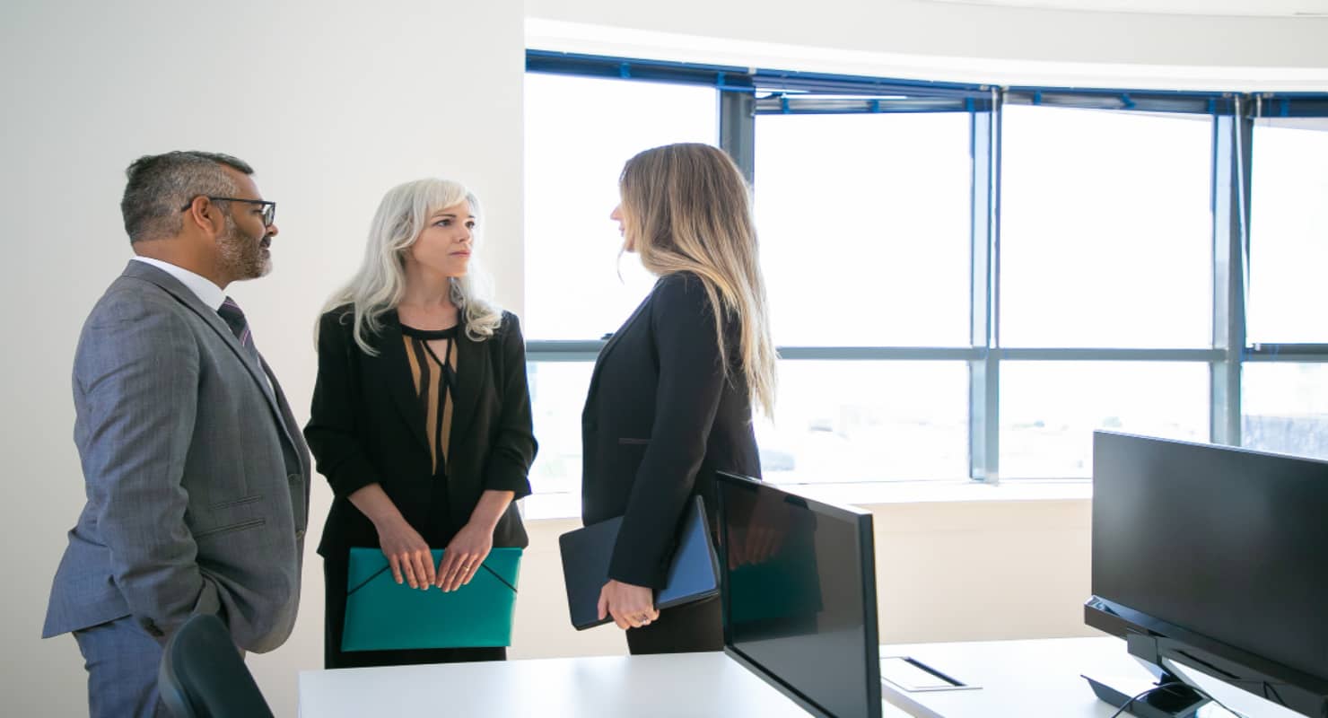 Experienced colleagues standing in office room